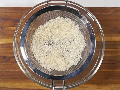 dry rice in the colander or on a cloth