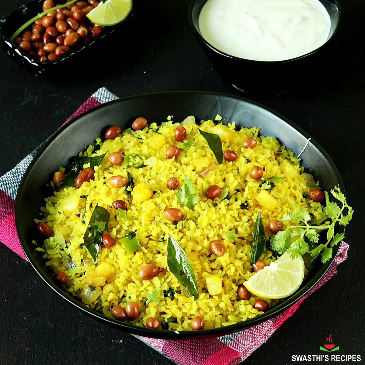 Poha is flattened rice, served in a black plate
