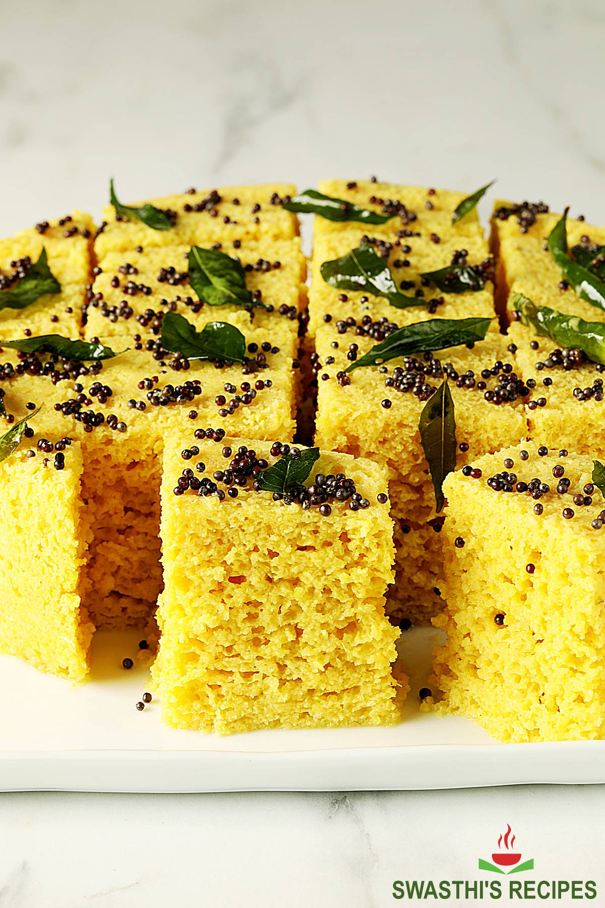 Dhokla also known as khaman dhokla served in a white tray