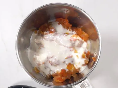 add yogurt and onion tomato masala to a grinder