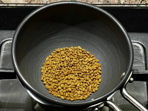 cooling roasted methi seeds for tomato pickle