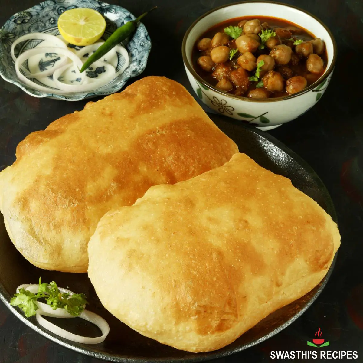 Bhatura with chole served with onions and lemon
