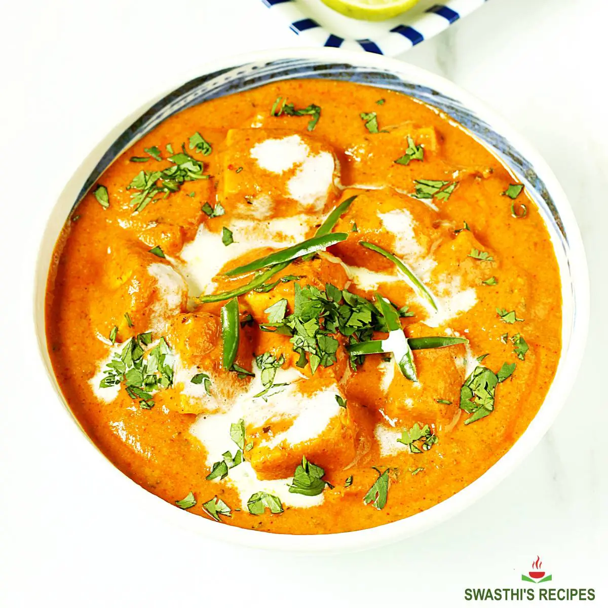 Paneer tikka masala served in a white bowl