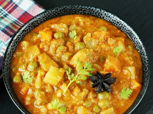 veg kurma also known as vegetable korma served in a black bowl