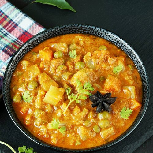veg kurma also known as vegetable korma served in a black bowl