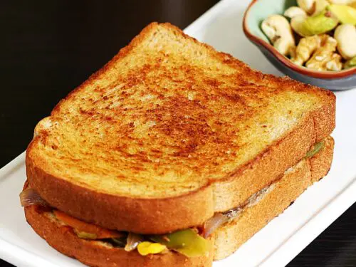 Veg sandwich also known as vegetable sandwich served in a white plate