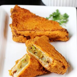 Bread pakora served in a white plate