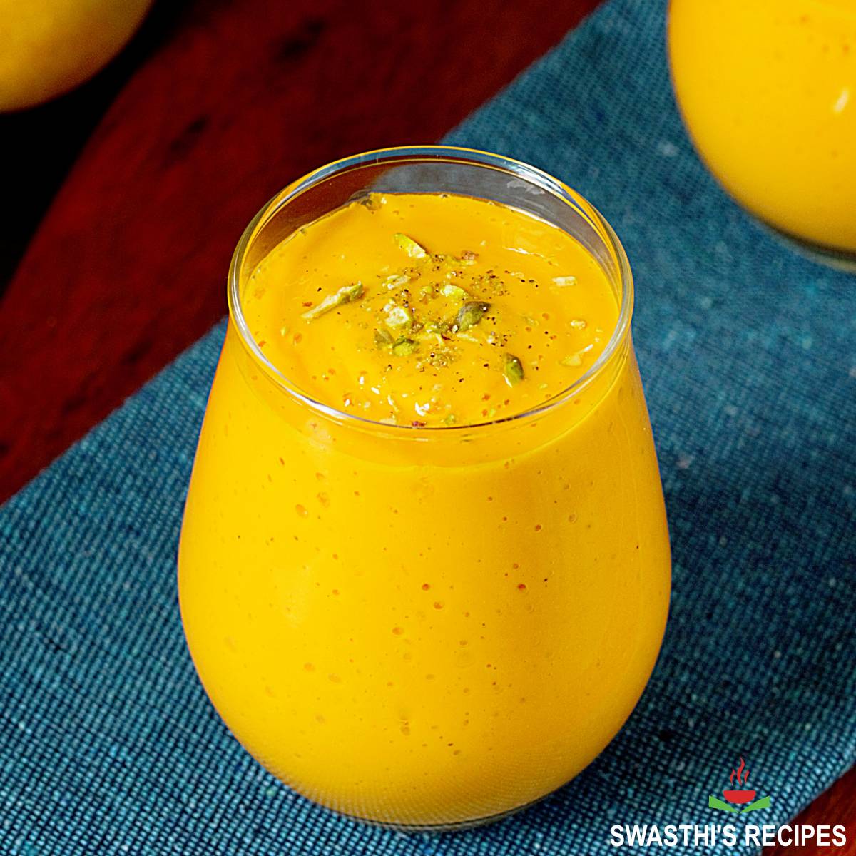 Mango lassi recipe made with mangoes, sugar, yogurt and milk