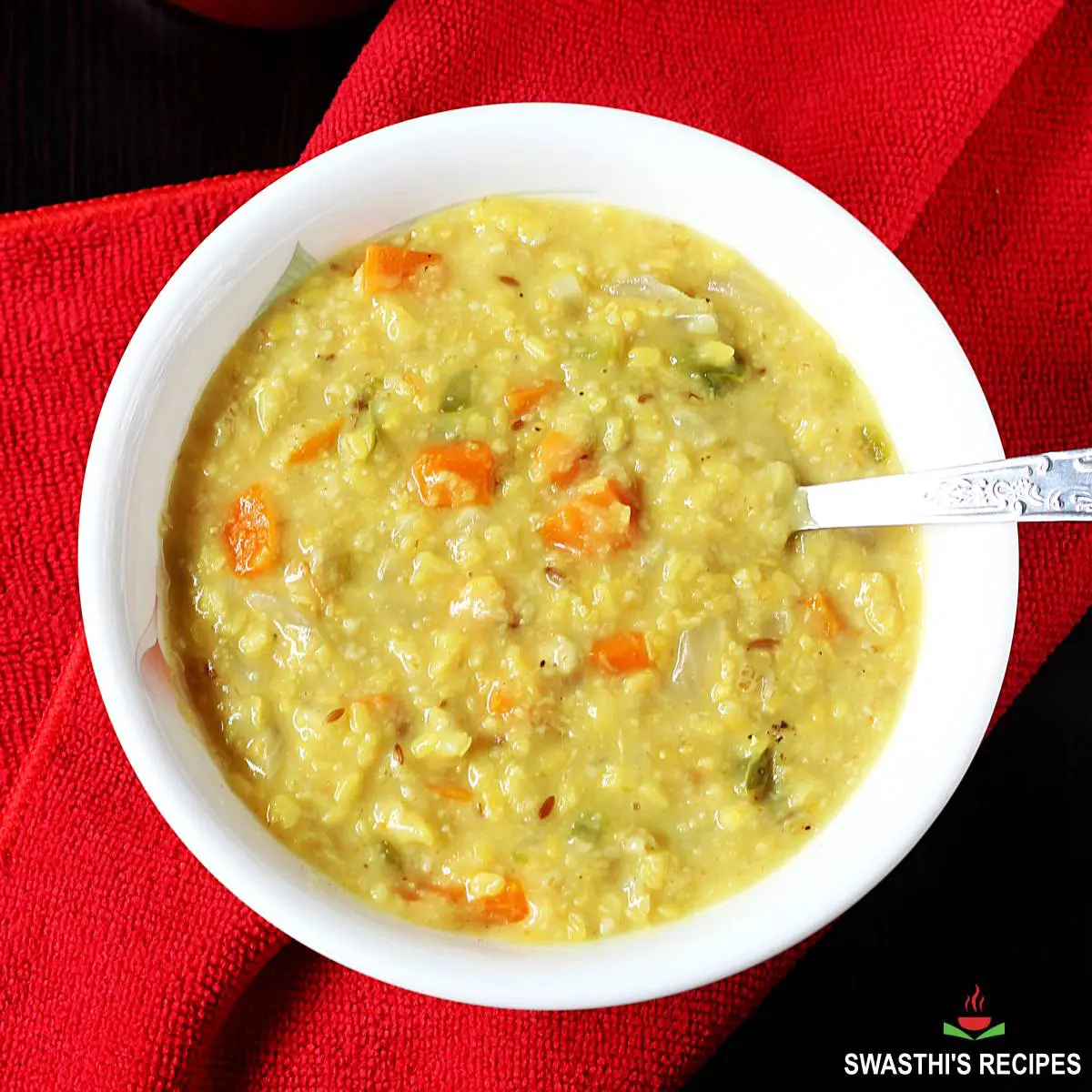 Oats khichdi served in a white bowl