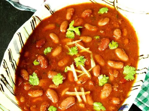 Rajma recipe made with red kidney beans, spices, onions and tomatoes