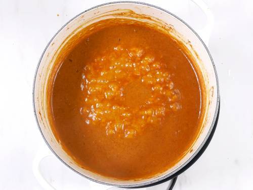 simmering tikka masala gravy before adding grilled chicken