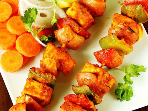 paneer tikka is a grilled tandoori appetizer made with paneer and spices