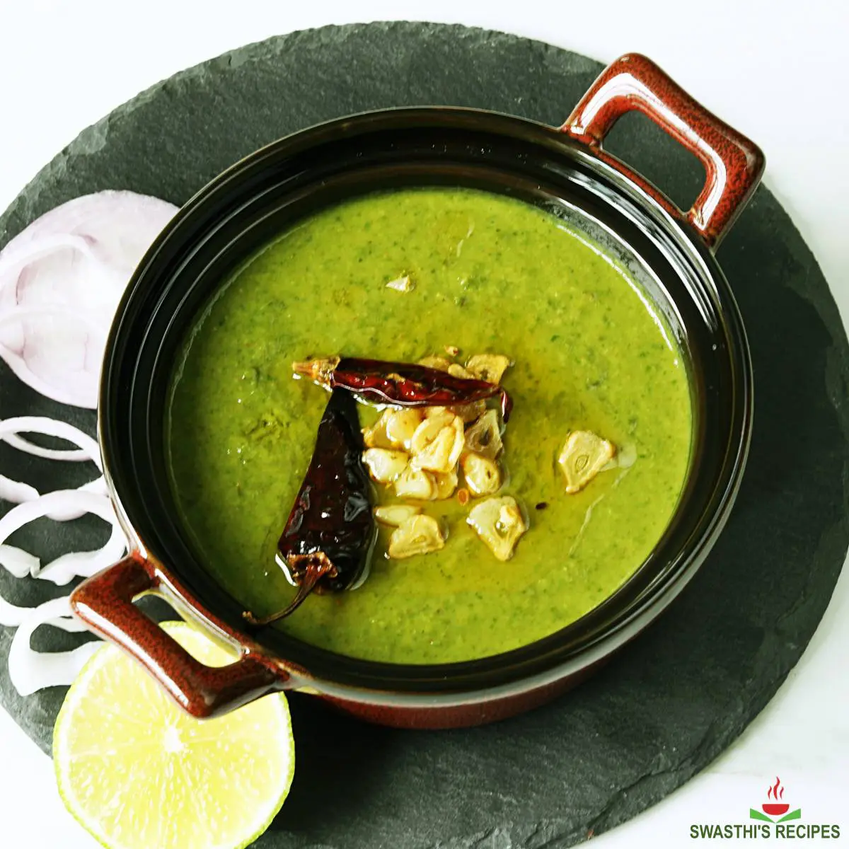 Spinach curry served in a brown bowl