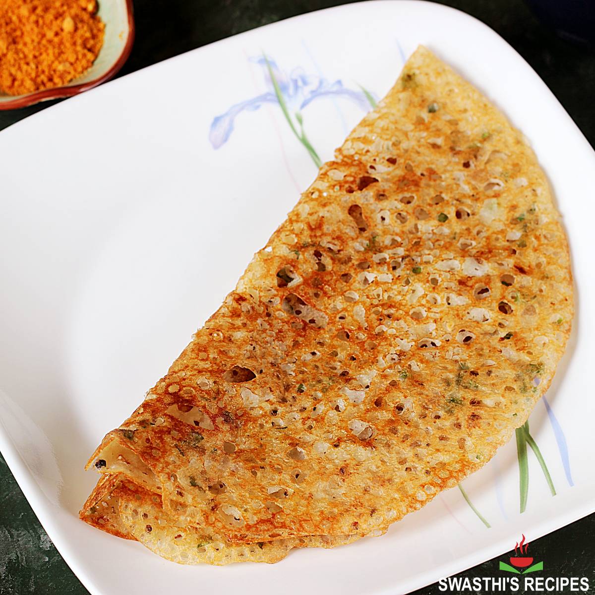 Wheat dosa also known as godhuma dosa served in a white plate