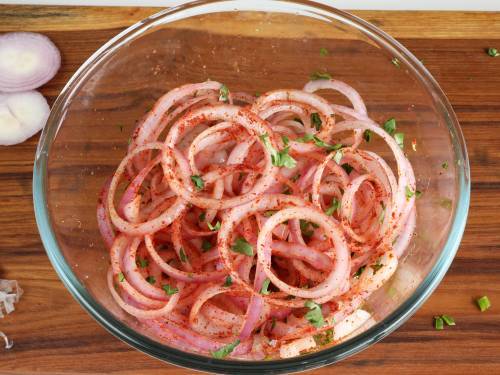 tossed onions with spices in a bowl