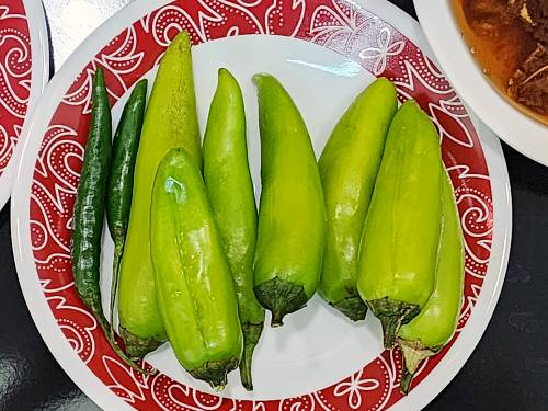 slit green chilies ready to go in the curry