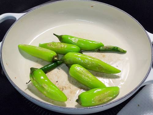 blistering green chilies in hot oil