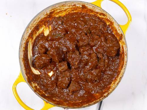 Finished Lamb Vindaloo with thick sauce in a braiser