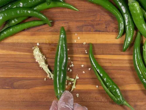 deseeding green chilies for making bajji