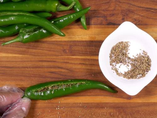 stuffing the chilies with spices