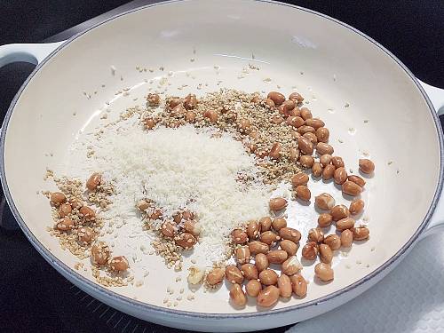 roasting sesame and coconut in a pan