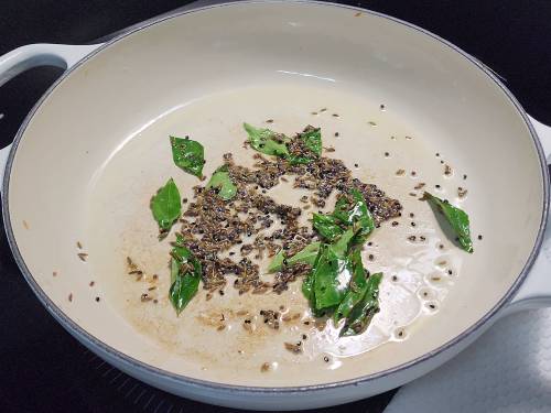 tempering spices in a pan