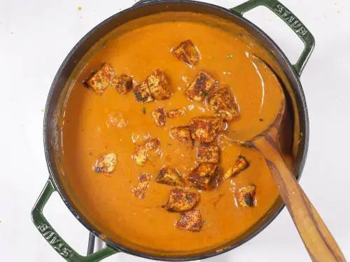 tofu curry simmering in a pan