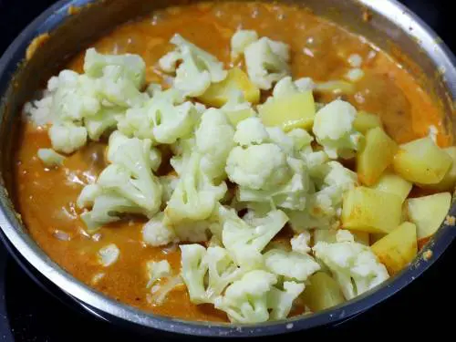 add steamed potatoes and cauliflower to the prepared masala