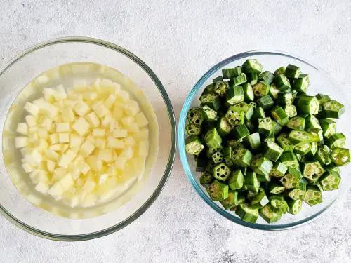 diced potatoes in water and chopped bhindi