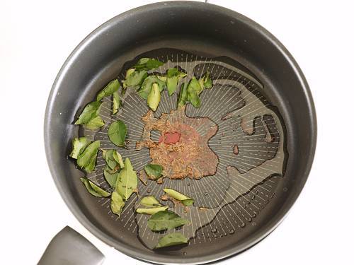 tempering spices to make eggplant potato curry