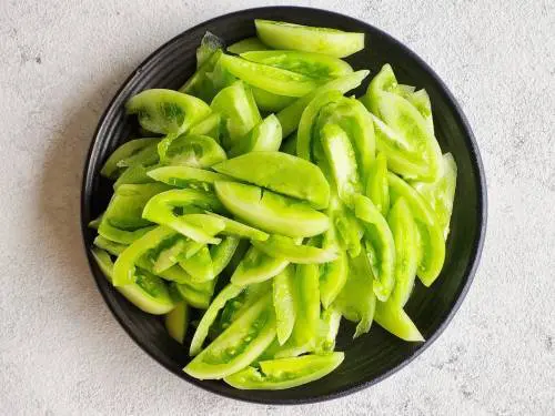 sliced green tomatoes to make chutney