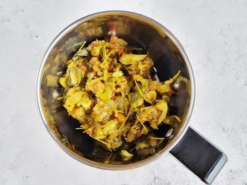 cooked green tomatoes in a grinder