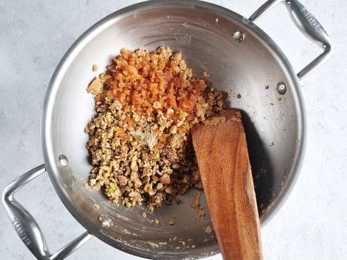 adding gond and nuts to pinni mixture