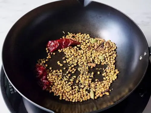 roast spices in a wok