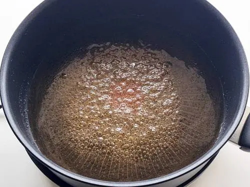 bubbling sugar syrup to make badam burfi