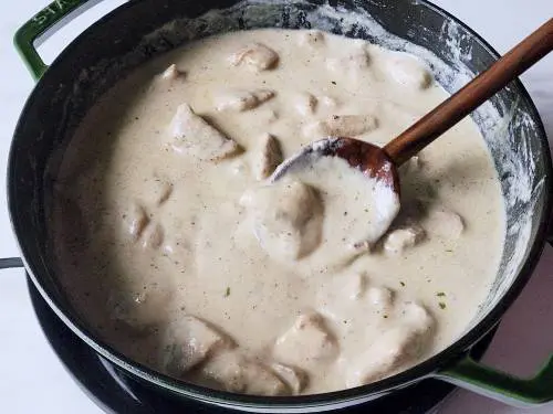 thick and creamy malai chicken in a dutch oven