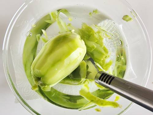 peel chayote in a bowl of water