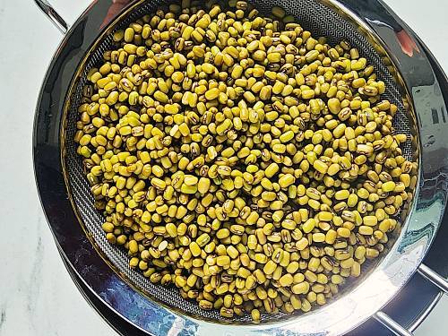 soaked mung beans in a strainer