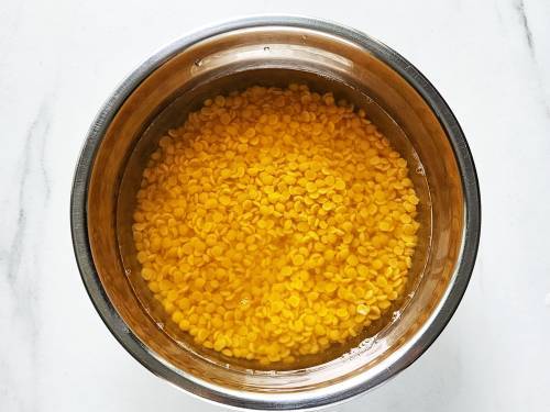 toor dal with water, ready to cook in a pressure cooker