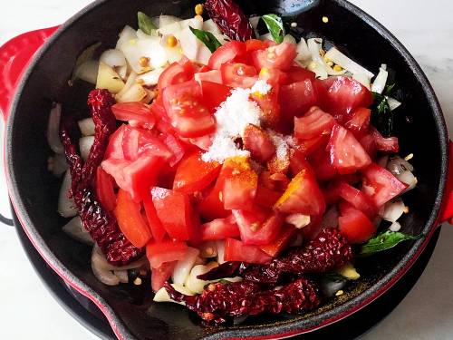 tomatoes, salt and turmeric in a pan to make chutney