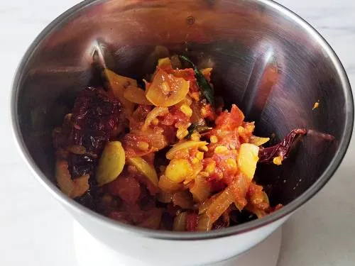 ingredients in a blender to make onion tomato chutney