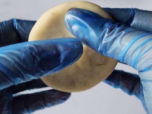 shaping stuffed kachori with fingers