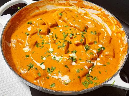 garnishing with cilantro and cream