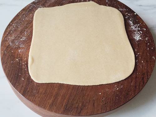 rolled square paratha on a rolling board