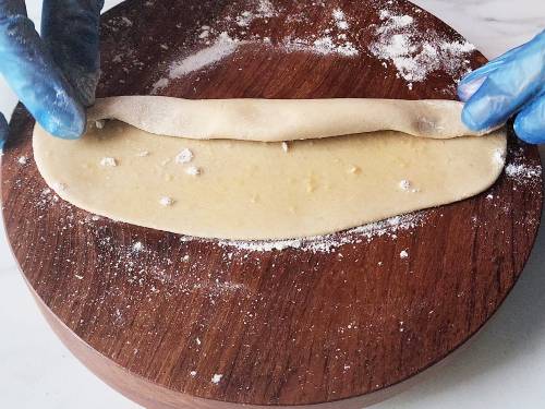 rolling the dough to a log