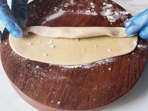 rolling the dough to a log