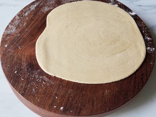 rolled dough on a wooden rolling board
