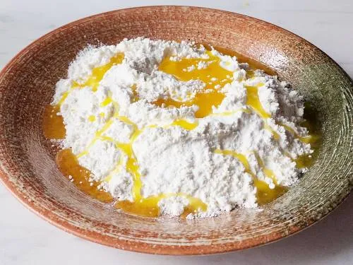 adding ghee to flour