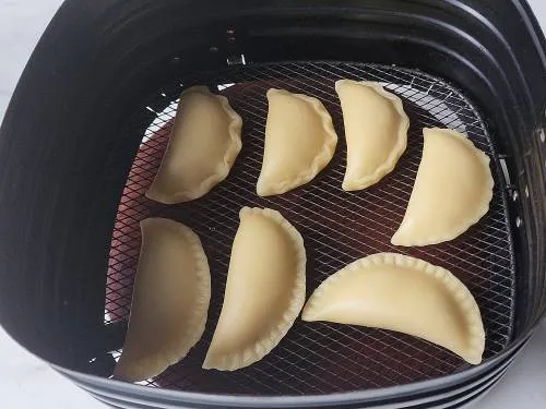 gujiyas in air fryer basket