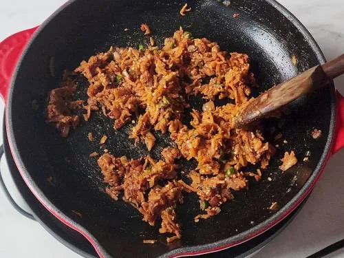 sauteed carrots in a pan for kulcha stuffing